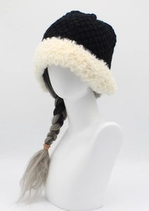 Detailed view of the winter knit beanie featuring plush white faux fur brim and black texture