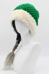 Detail of green knit earflap hat with cream faux fur lining and braided hair extensions