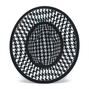 Detail view of houndstooth felt hat interior showing the 65% cotton blend fabric label