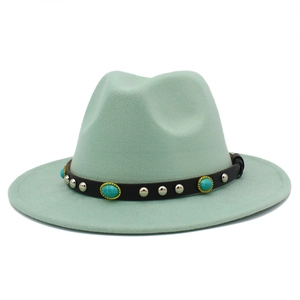 Detail of mint green fedora featuring black leather band with silver studs and turquoise