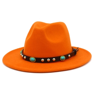 Close-up of orange fedora hat with turquoise stones and silver studs on black leather band