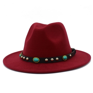 Detail eines burgunderfarbenen Fedora-Hutes mit Lederband, Türkissteinen und goldfarbenen Nieten