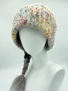 Close-up of thick rainbow knit bucket hat on mannequin showing colorful yarn texture