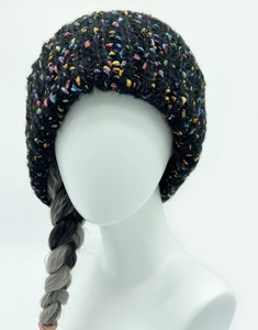 Close-up of a chunky black knit beanie with colorful rainbow speckles and thick texture