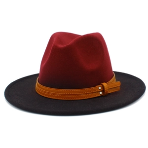 Close-up of two-tone burgundy and black wool fedora with brown leather rivet band