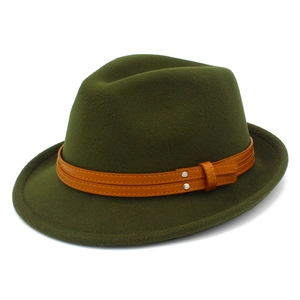 Detail view of olive green fedora hat featuring orange decorative strap and silver studs