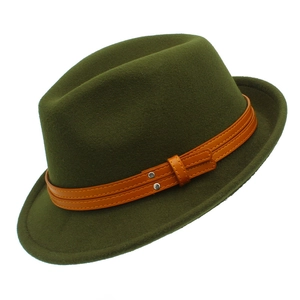 Close-up of olive green wool fedora with orange leather bands and silver metal studs