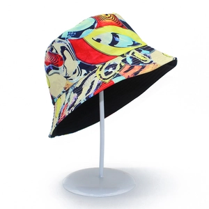 Detail of artistic graffiti print bucket hat with reversible black lining on stand