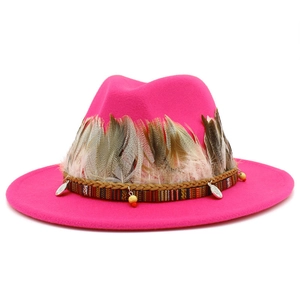 Elegant rose pink fedora hat with wide brim and bohemian feather band decoration