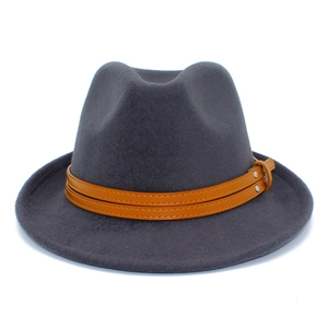 Detail of dark grey wool fedora hat with brown leather band and silver metal rivets