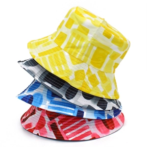 Pack of four colorful patterned bucket hats for men and women stacked on white background
