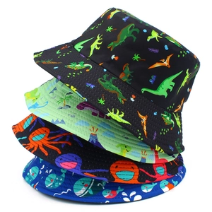 Close-up of four stacked bucket hats with dinosaur and ocean cartoon prints for sun protection