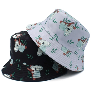Detail view of black and lilac bucket hats with cute cartoon koala and leaf patterns