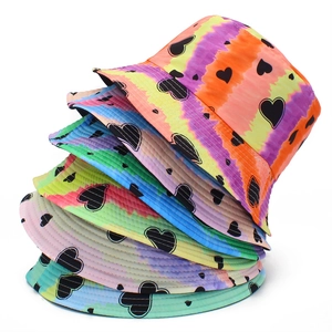 Stack of tie-dye bucket hats with black heart print in various vibrant color patterns