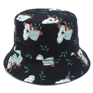 Detailed view of black bucket hat with cartoon koala and green leaf print patterns