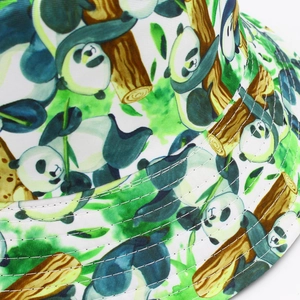 Close-up of white bucket hat with hand-drawn panda patterns and reinforced brim stitching