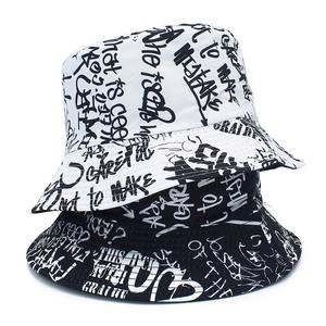 Close-up of black and white graffiti bucket hats with street style typography prints