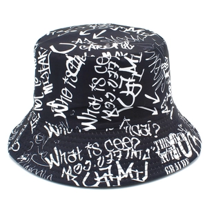 Close-up of black bucket hat featuring all-over white graffiti print and street style