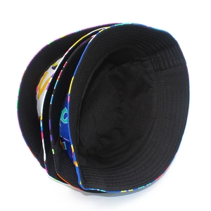 Macro shot of stacked graffiti style bucket hats showing vibrant colors and cotton canvas texture