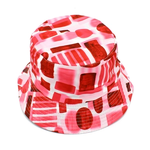 Detail of artistic bucket hat with red and pink geometric patterns on canvas fabric