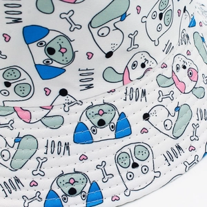 Detail of white bucket hat with cartoon dog prints, bones, hearts and WOOF letters