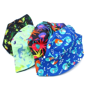 Detail showing four assorted animal prints including dinosaurs, octopuses, and whales on hats