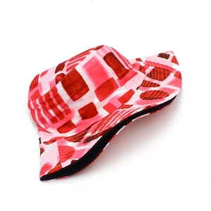Close-up of pink and white patchwork bucket hat with reinforced stitching and black lining