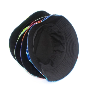 Detail of multi-pattern reversible bucket hats showing colorful prints and black lining