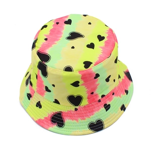 Detail view of tie-dye bucket hat with neon yellow and pink patterns and heart prints