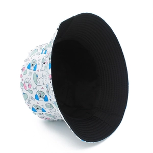 Detail view of cotton bucket hat with cartoon dog prints and WOOF text elements