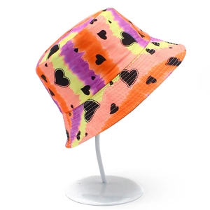 Detail of tie-dye bucket hat with colorful gradient and black heart patterns