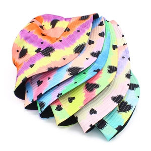 Tie-dye bucket hat with black heart prints in multiple gradient color options