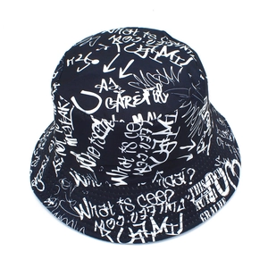 Close-up of black bucket hat featuring white graffiti lettering and smooth stitching