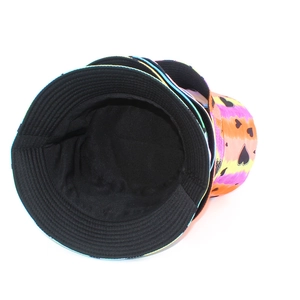 Detail view of tie-dye bucket hat with pink and orange gradients and black heart patterns