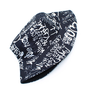 Detailed view of black bucket hat featuring white street graffiti and letter print
