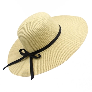 Beige wide brim straw hat with black ribbon bow for summer beach sun protection