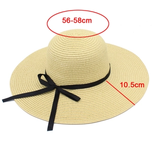 Detailed view of woven sun hat texture with 10.5cm wide brim and black ribbon bow detail