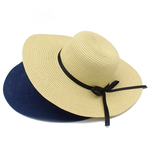 Women summer straw sun hat with wide brim and elegant black ribbon bow in beige and navy