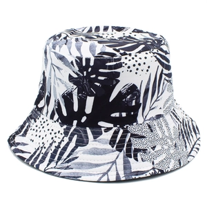 White bucket hat with navy tropical palm leaf print for sun protection and outdoor leisure