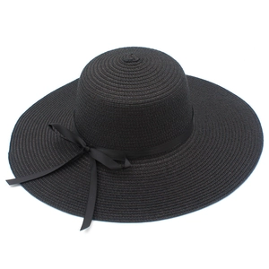 Women's foldable black wide brim straw hat with elegant satin bow for beach sun protection