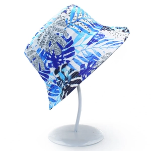 Detail of blue and white tropical palm leaf print bucket hat on a display stand