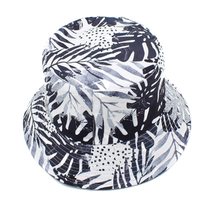 Detailed close-up of the black and white palm tree print on a stylish sun bucket hat