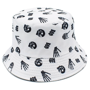 White canvas bucket hat featuring black skull prints and BOO text for street style wear