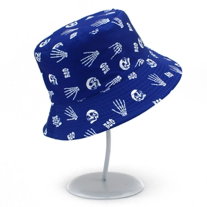 Detail view of the navy blue bucket hat with white skull patterns on a metal display stand