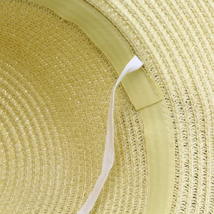 Detail view of woven straw sun hat interior featuring sweatband and adjustable elastic cord