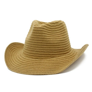 Macro detail of the woven texture and curved brim of this khaki straw jazz hat
