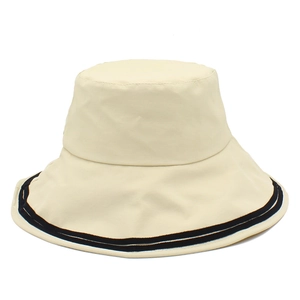 Detail shot of beige sun hat featuring double black stripes and premium canvas texture