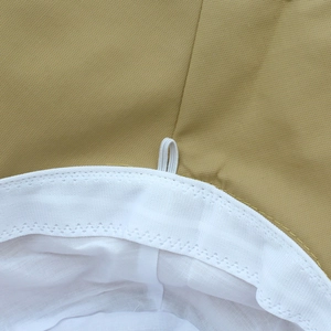 Detailed macro view of khaki sun hat featuring twill fabric and white elastic strap loop