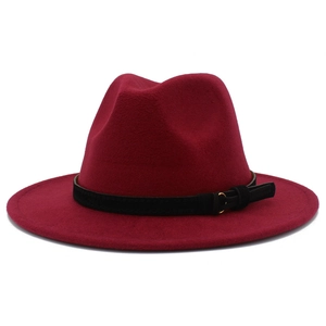 Detail of burgundy wool fedora hat with black suede band and golden buckle finish