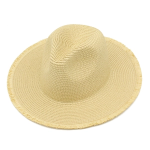 Close-up of lightweight raffia sun hat with raw frayed edges and fedora style crown